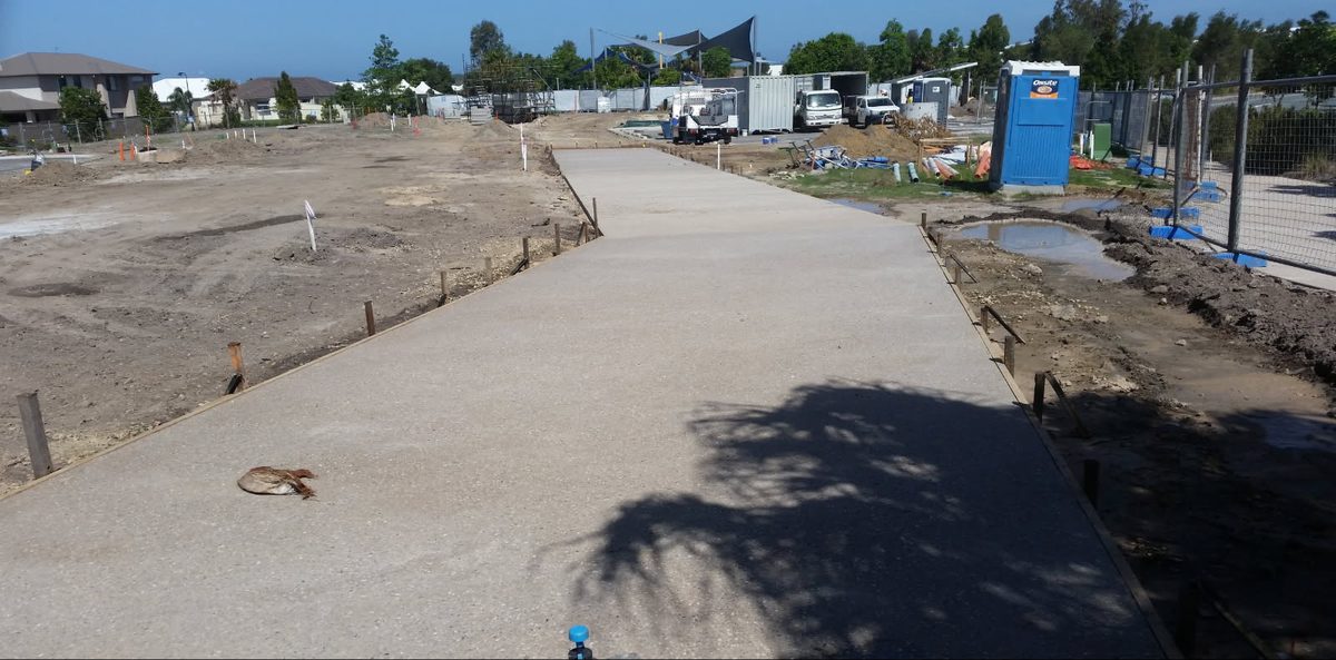 Long exposed aggregate concrete run freshly poured with forms still on