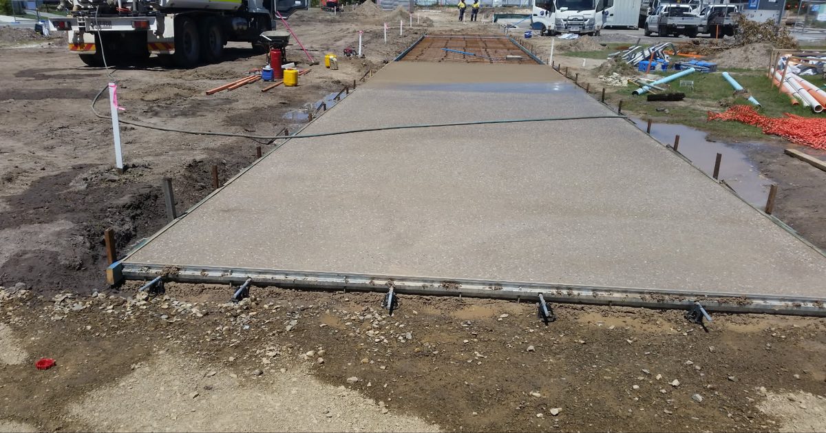 Fresh concrete pour with the next bay formed up and steel mesh in place behind it