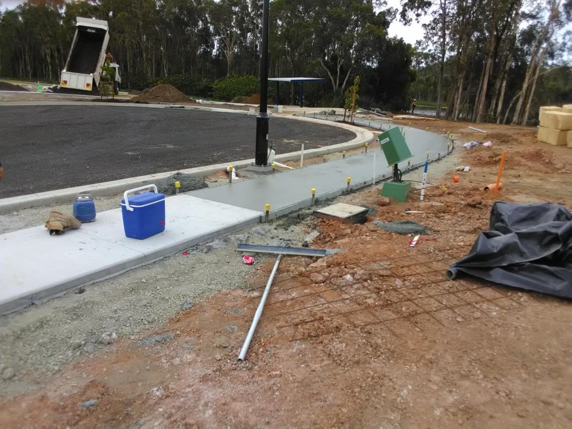Fresh kerbside concrete pour screeded off between forms in a new estate street